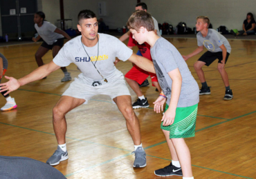 McCracken basketball camp coaches working on defensive drills