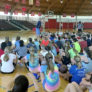 Coach addressing campers at basketball camp tis summer