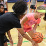 Basketball coaches working on offensive skills at camp